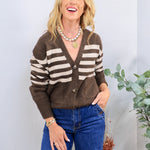 Brown and cream striped knit cardigan with button front, styled with blue jeans and pearl necklace.