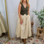 Olive green button-front vest bodice midi dress with cream full skirt, styled with brown ankle boots and layered gold necklac