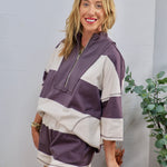 Purple and cream wide-stripe half-zip pullover top with matching shorts set, styled casually.