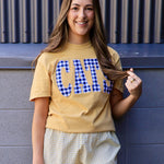 Yellow "CATS" gingham appliqué tee styled with matching plaid smocked shorts, worn by smiling brunette model.