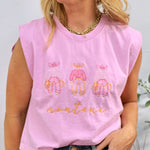 Woman wearing pink sleeveless muscle tee with three cowboy figures and "montana" text, styled with jeans and gold chain neckl