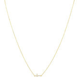 Gold delicate cable chain necklace with pavé crystal sideways cross pendant on white background
