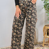 Wide-leg floral print denim jeans in dark black with dusty rose and sage blooms, styled with black long-sleeve top and tan booties