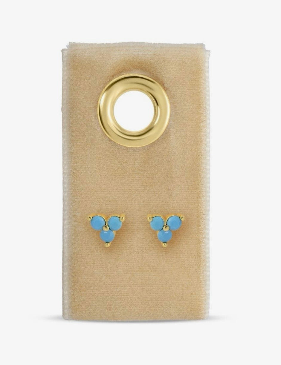 Gold-tone turquoise three-stone cluster stud earrings displayed on a beige velvet card
