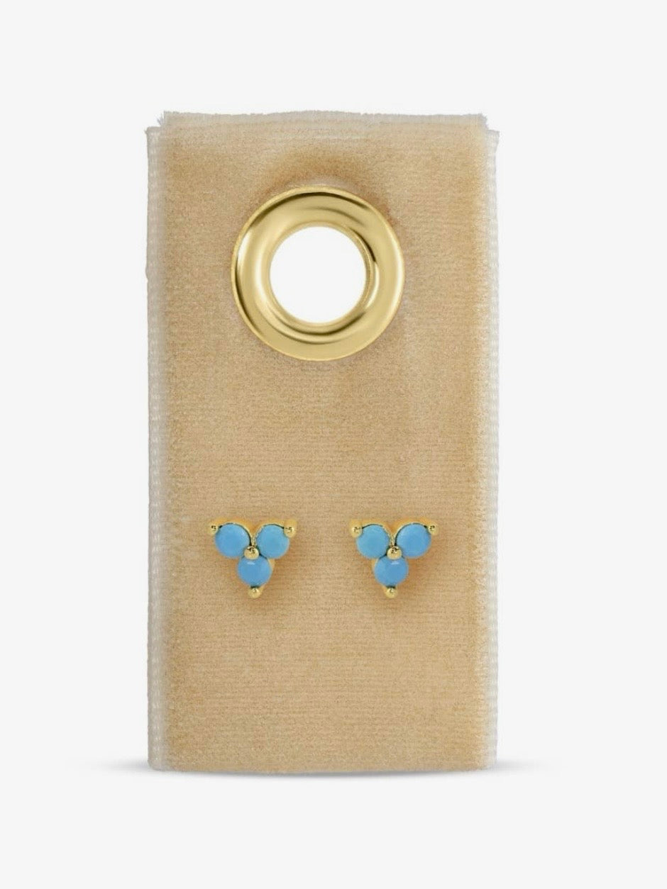 Gold-tone turquoise three-stone cluster stud earrings displayed on a beige velvet card