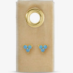 Gold-tone turquoise three-stone cluster stud earrings displayed on a beige velvet card