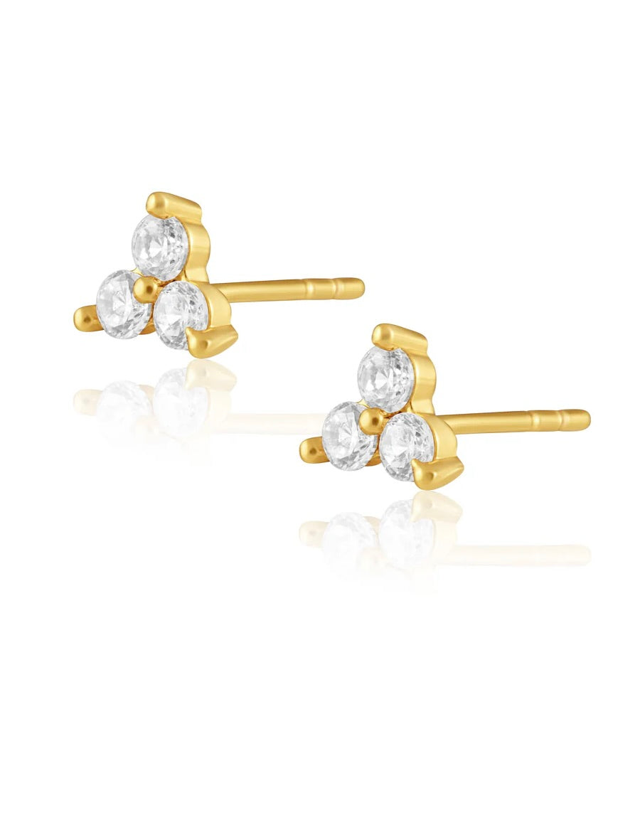 Gold stud earrings with three round clear crystals arranged in triangular cluster formation on white background.