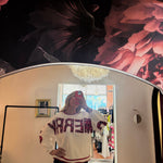 White crewneck sweatshirt with red sequin "MERRY" lettering, red striped trim, styled with dark jeans, mirror selfie.