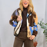 Multicolor sherpa patterned jacket in brown, blue, and tan, styled over dark brown turtleneck and pants.