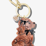 Brown acrylic resin dachshund dog keychain with black bow tie detail and gold carabiner clip.