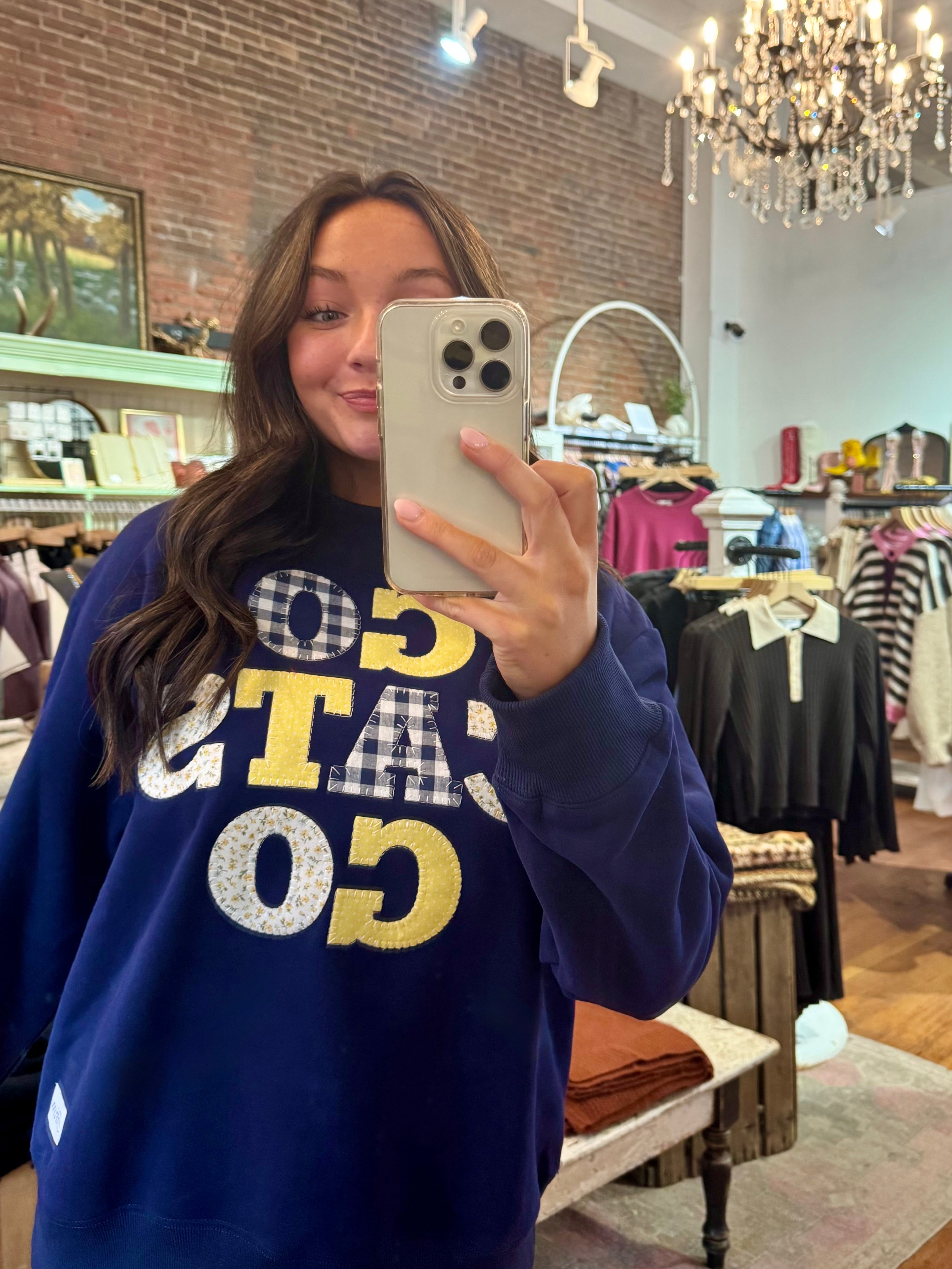 Navy blue "Go Cats Go" graphic crewneck sweatshirt with patchwork gingham and floral appliqué lettering in gold and white.