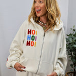 Woman wearing cream zip-up hoodie with colorful chenille HO HO HO holiday lettering on chest