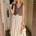 Woman wearing olive contrast vest midi dress with cream skirt, woven bag, and oversized sunglasses