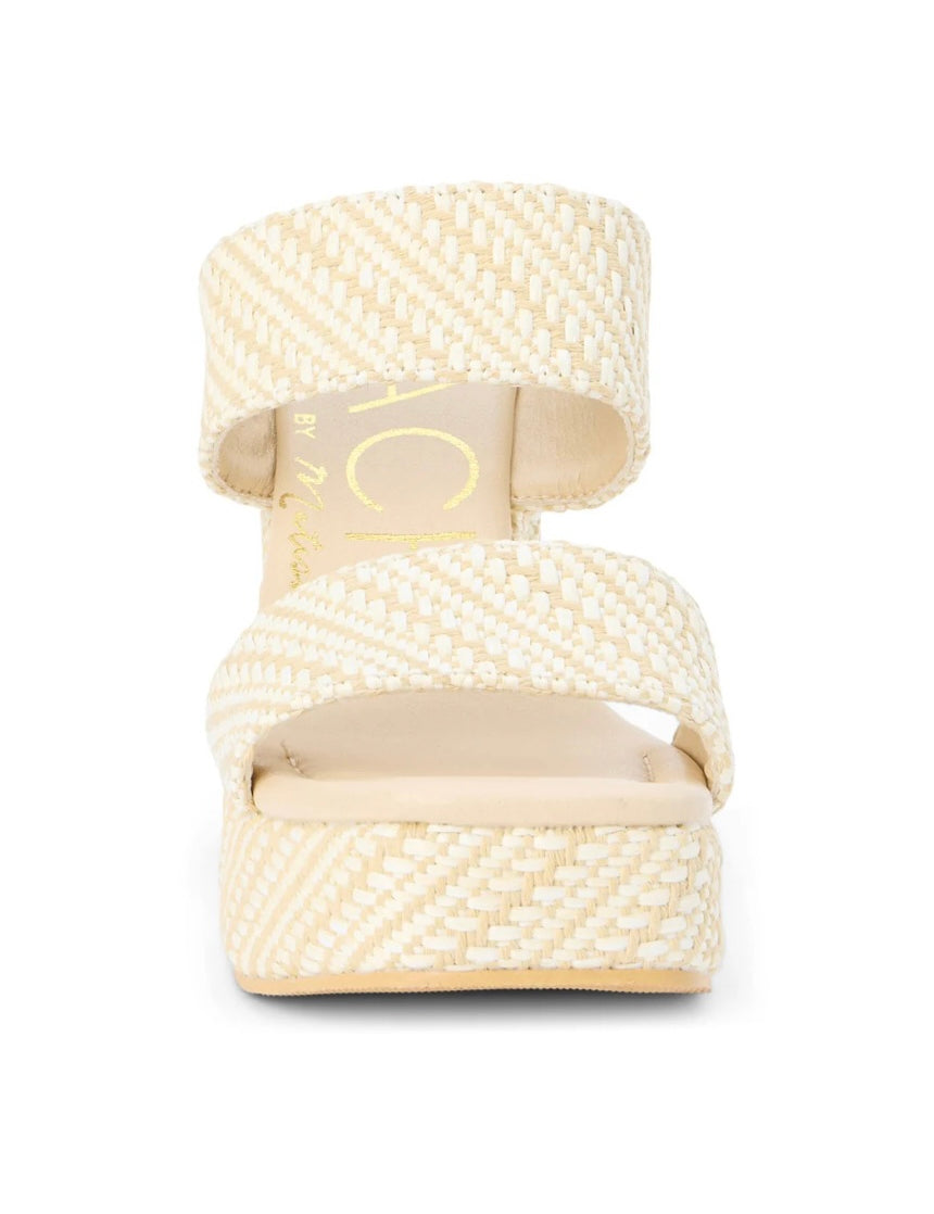 Cream woven raffia platform sandal with two wide straps and espadrille-style flatform sole.