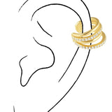 Gold tone triple band ear cuff with crystal details worn on illustrated ear