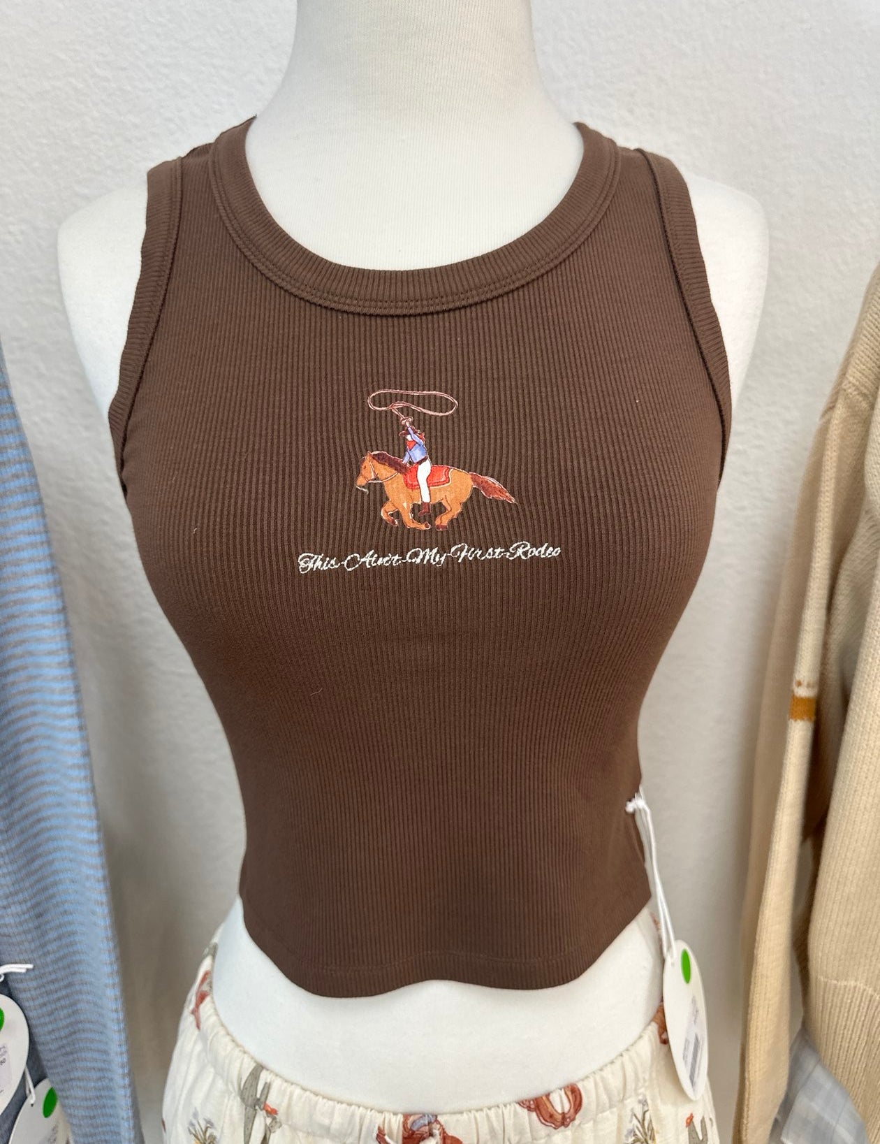 Brown ribbed sleeveless tank top with embroidered cowboy on horse graphic and text