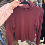 Burgundy cropped long sleeve mock turtleneck top with ruffle lettuce-edge collar on hanger