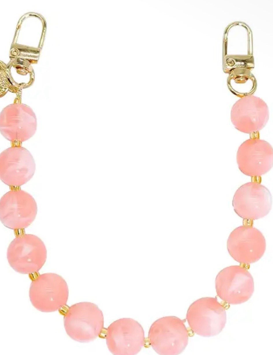 Pink beaded bag chain strap with gold lobster clasp hardware and small gold spacer beads.